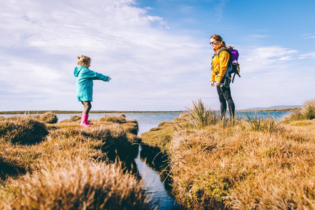mother and daughter standing on cliffs