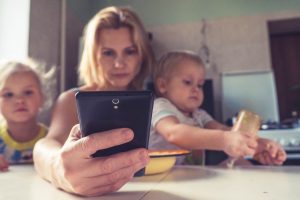 woman in white shirt holding black ipad